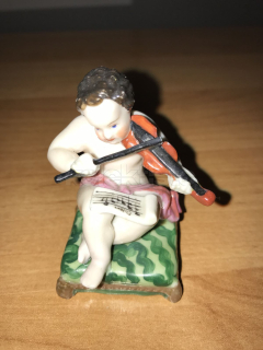 Porcelánová soška dítěte hrajícího na housle